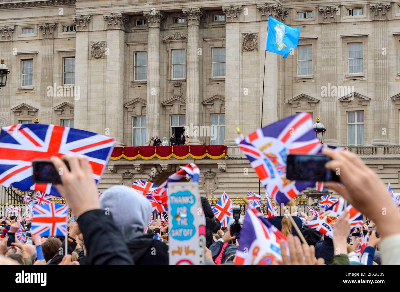 Crowds outside Buckingham Palace at the Queens Diamond Jubilee celebration in London, UK, with The Queen and family on the balcony in distance Stock Photo