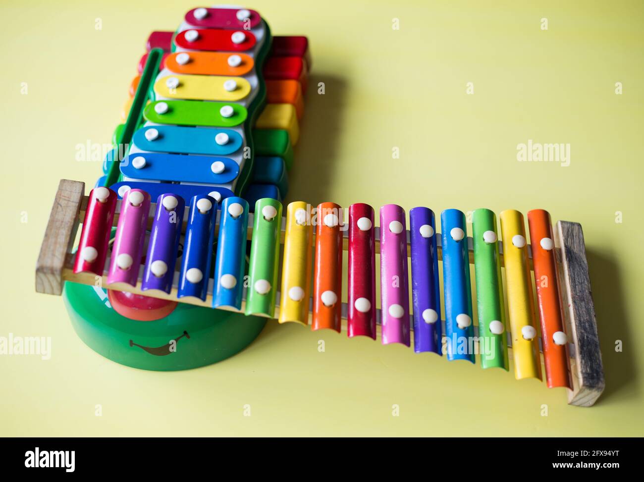 Overhead shot of toy xylophones music equipment on a yellow surface