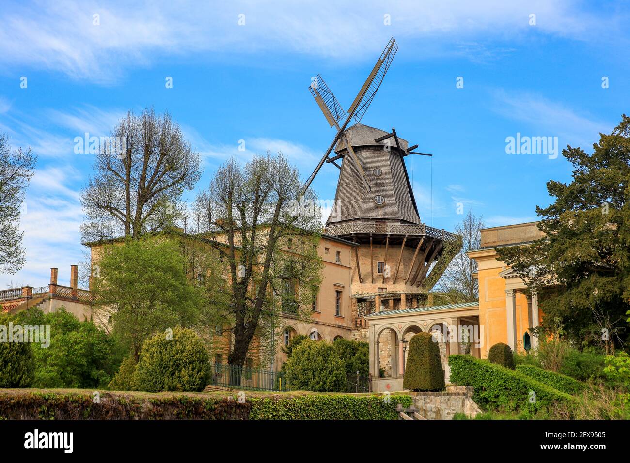 Old windmill made of wood . Blue sky on the background Stock Photo