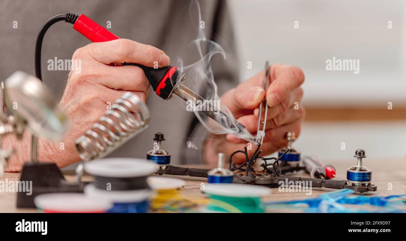 Man repairing black iron hi-res stock photography and images - Alamy