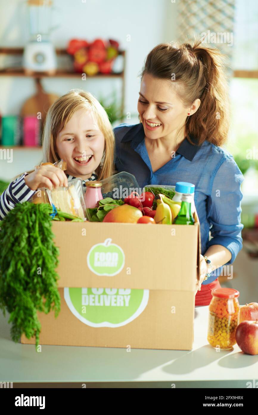 Food delivery. happy modern mother and child with food box in the