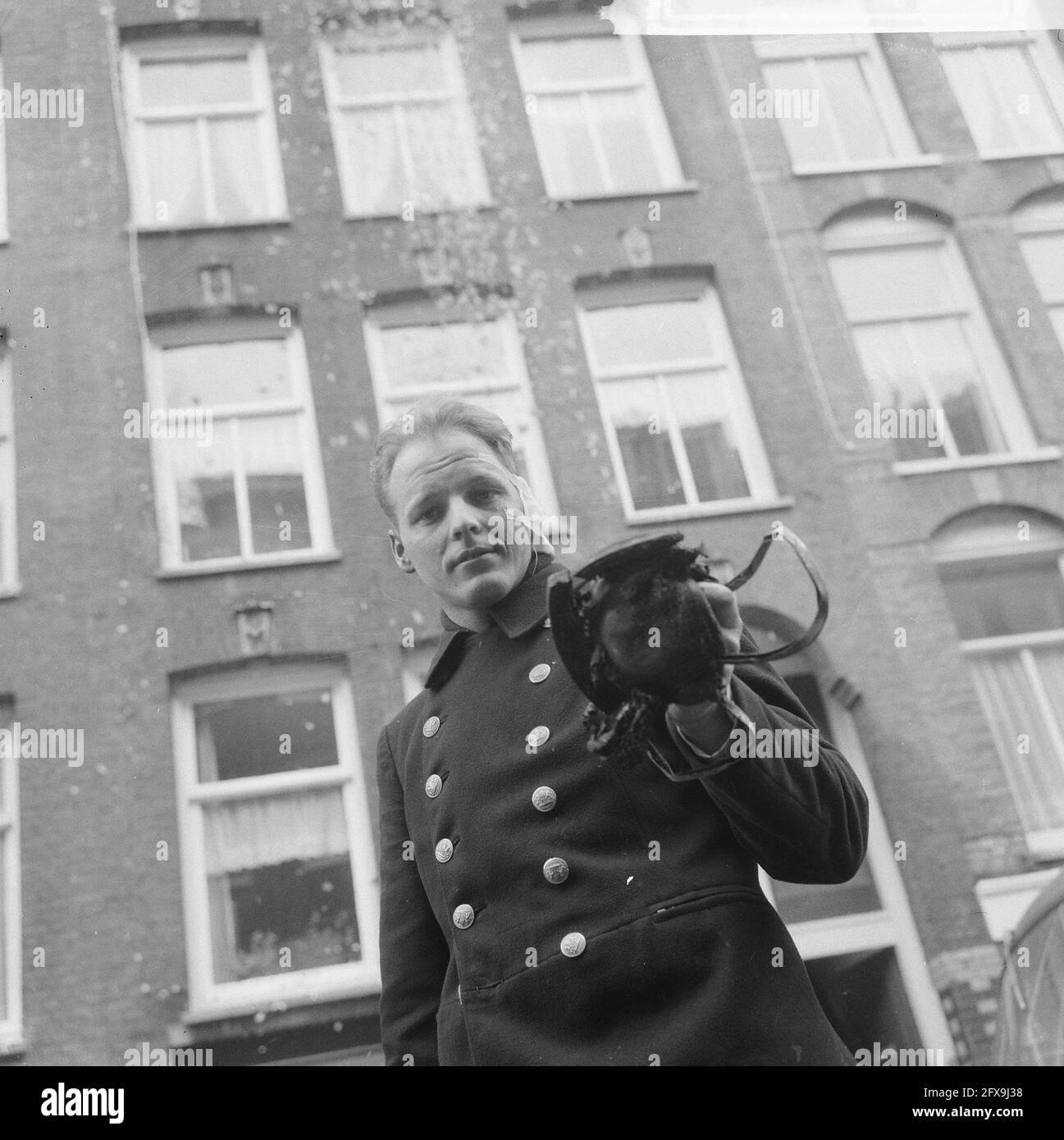 Fire in Second Van der Swindenstraat, Firefighter Goldst with his burned ear and helmet, February 18, 1966, FIRE, FIREWORKS, helmets, The Netherlands, 20th century press agency photo, news to remember, documentary, historic photography 1945-1990, visual stories, human history of the Twentieth Century, capturing moments in time Stock Photo