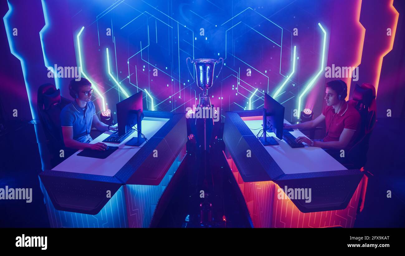 Two Professional Esport Gamers Actively Compete in Video Game Playing on Championship Event with Big TV Screens