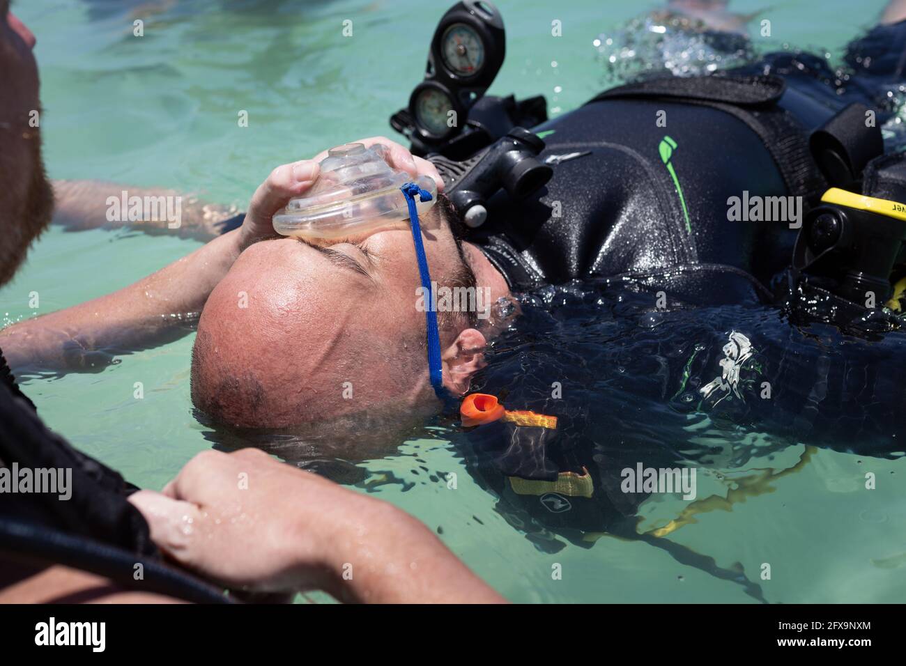 Panglao, Philippines - April 29, 2021: Scuba diver, instructor in confined water teaching, studying, evaluating skills, rescue skills Stock Photo