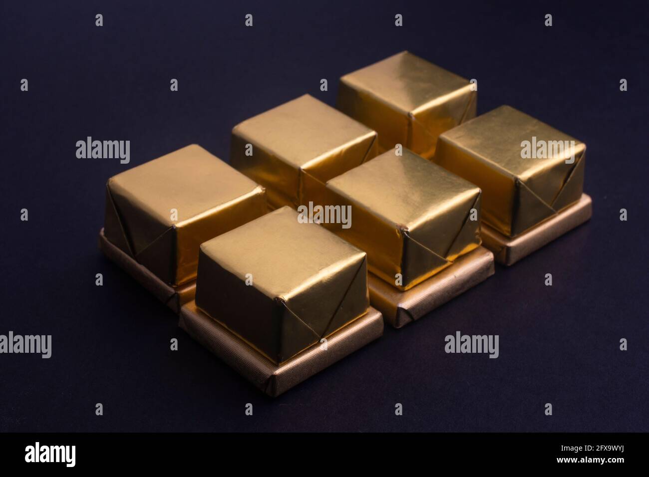 chocolates in gold foil Stock Photo Alamy