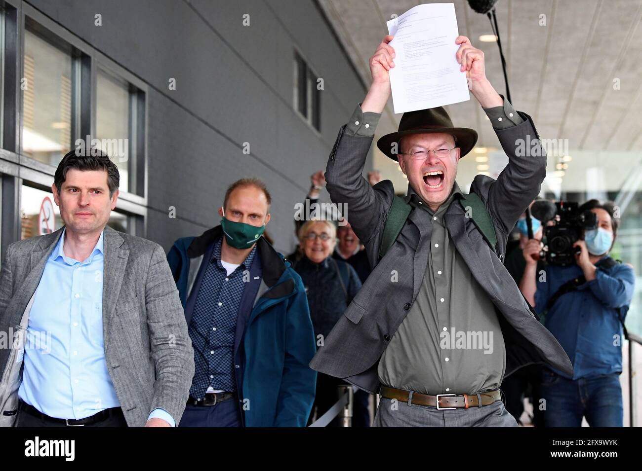 Donald Pols, Director of Milieudefensie (Friends of the Earth), reacts holding a copy of a verdict in a case brought on against Shell by environmentalist and human rights groups, including Greenpeace and Friends of the Earth, who demand the energy firm to cut its reliance on fossil fuels, in The Hague, Netherlands, May 26, 2021. REUTERS/Piroschka van de Wouw Stock Photo