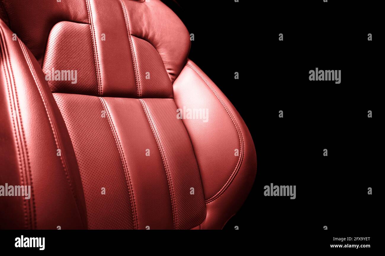 Modern luxury car red leather interior. Part of red perforated leather