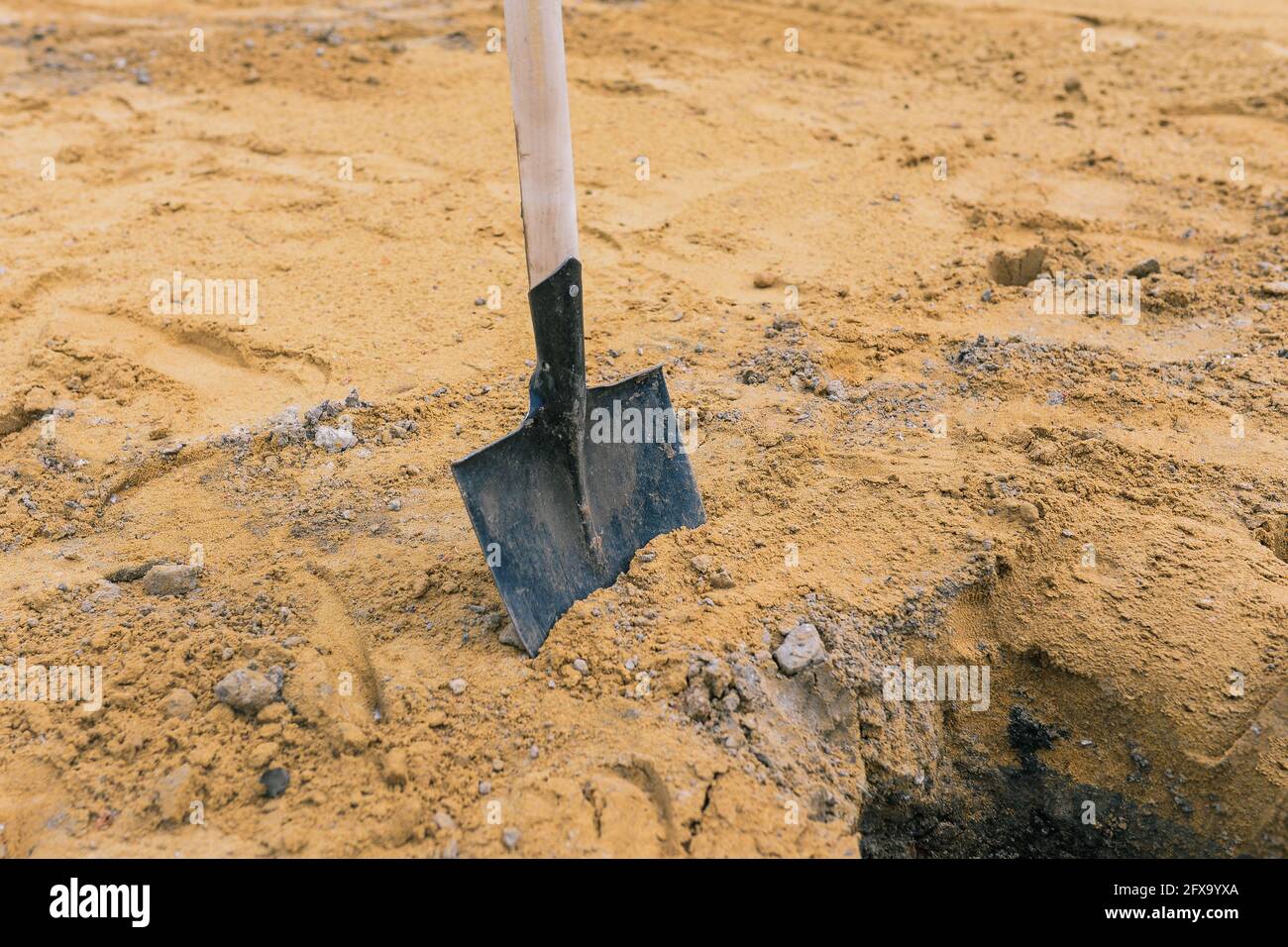 Shovel in the sand. Tool for construction work and work on the land. Planting trees and plants. Stock Photo