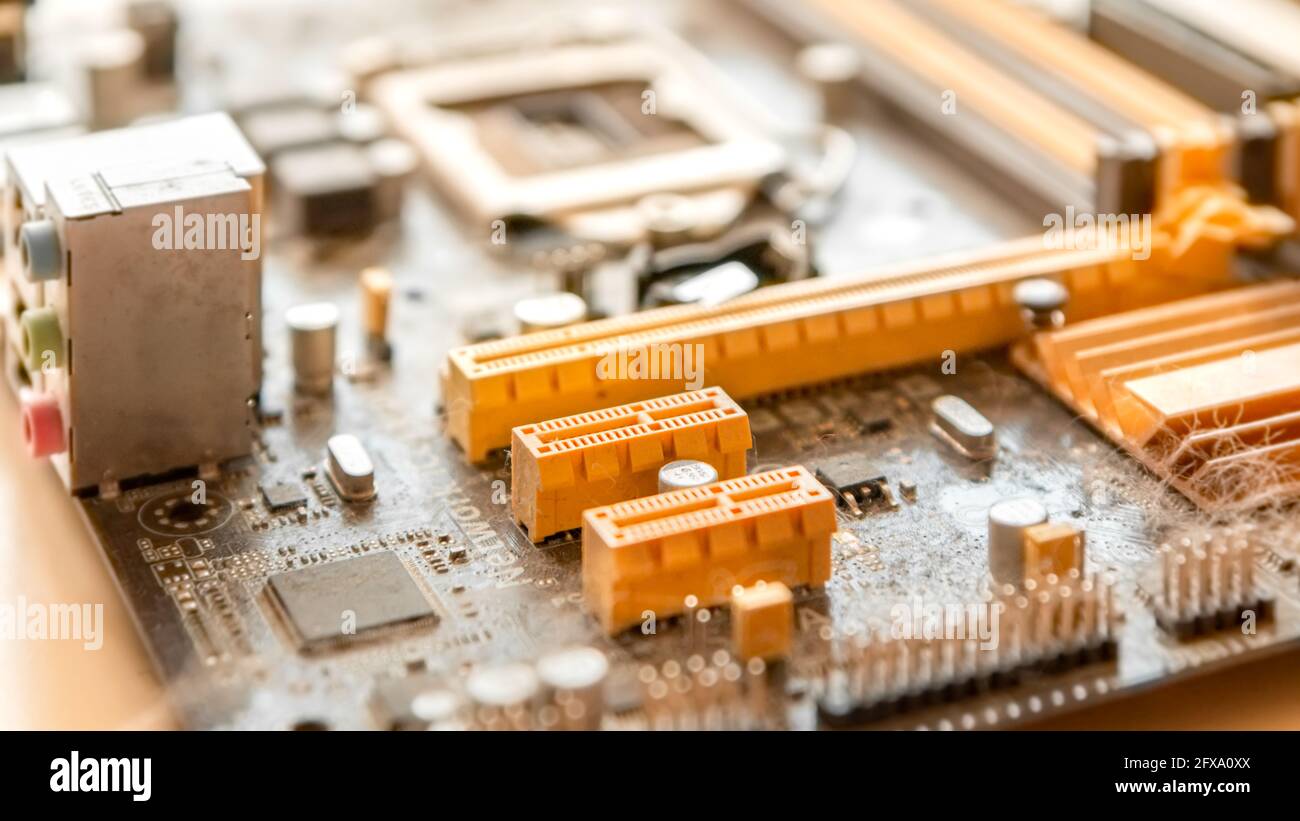 Part of an old dusty motherboard with cobwebs with various connectors to  accommodate additional modules Stock Photo - Alamy