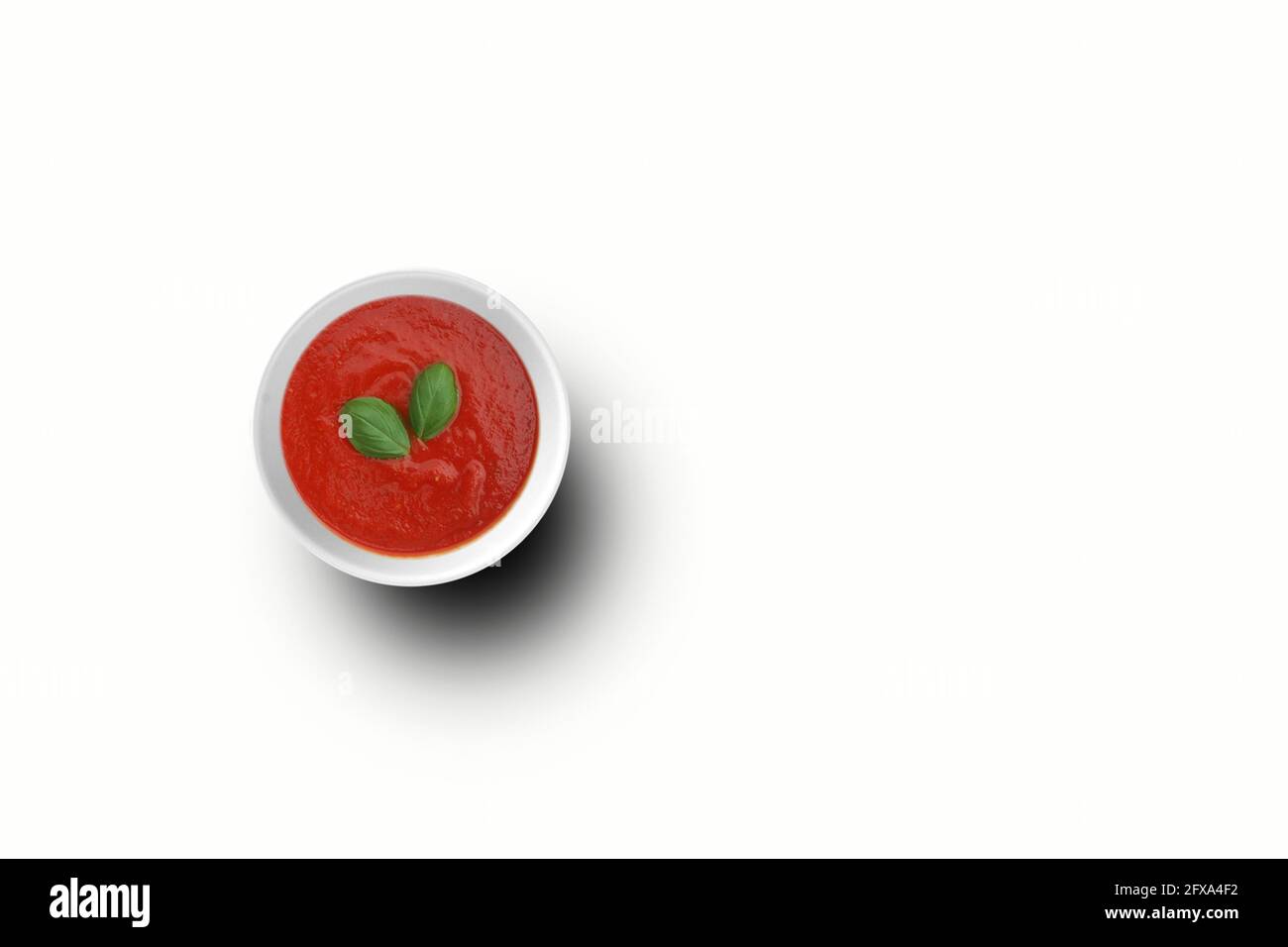 Top up view tomatoes ketchup on white bowl with two leaves . Top up view tomatoes ketchup on white bowl . fit for your design element. Stock Photo