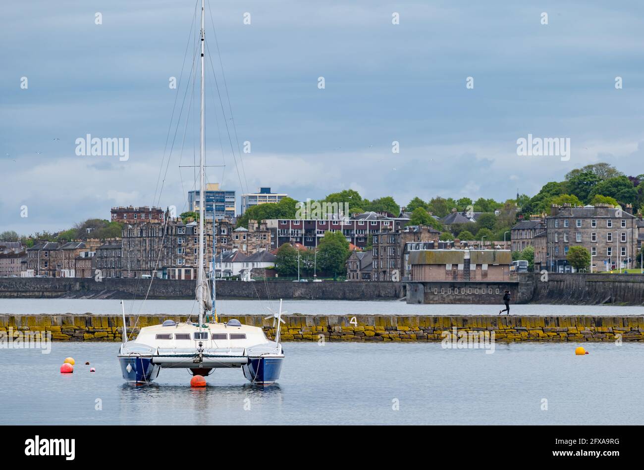 Edinburgh, Scotland, United Kingdom, 26th May 2021. A catamaran sailing boat moored in Granton harbour Stock Photo