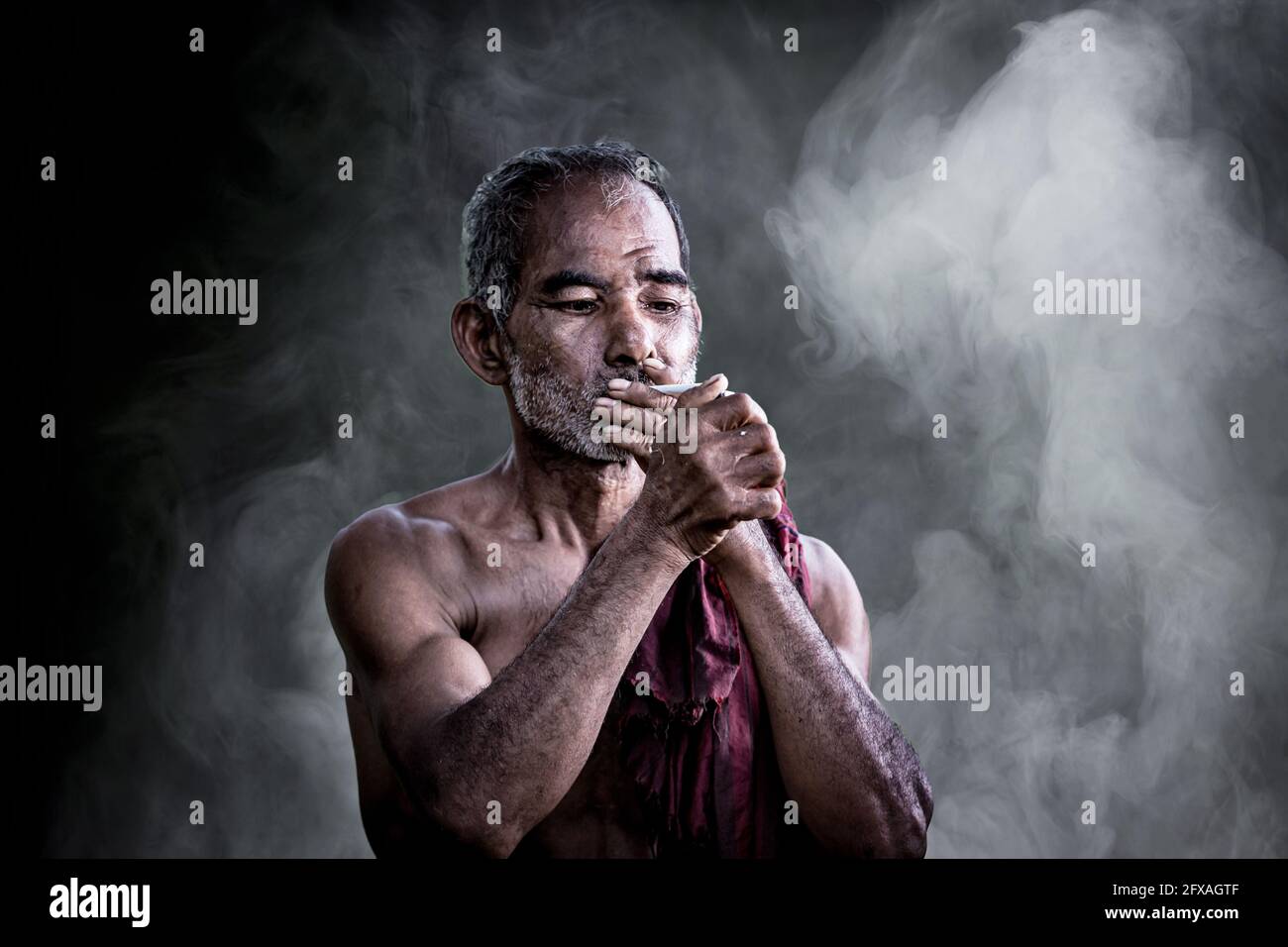 dark and sullen shot of a old man smoking over a black background Stock ...