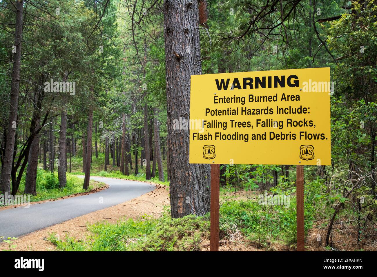 A sign warns that travelers are entering a wildfire burn area.  Captured near the Pit River in Shasta County, Californai, USA. Stock Photo