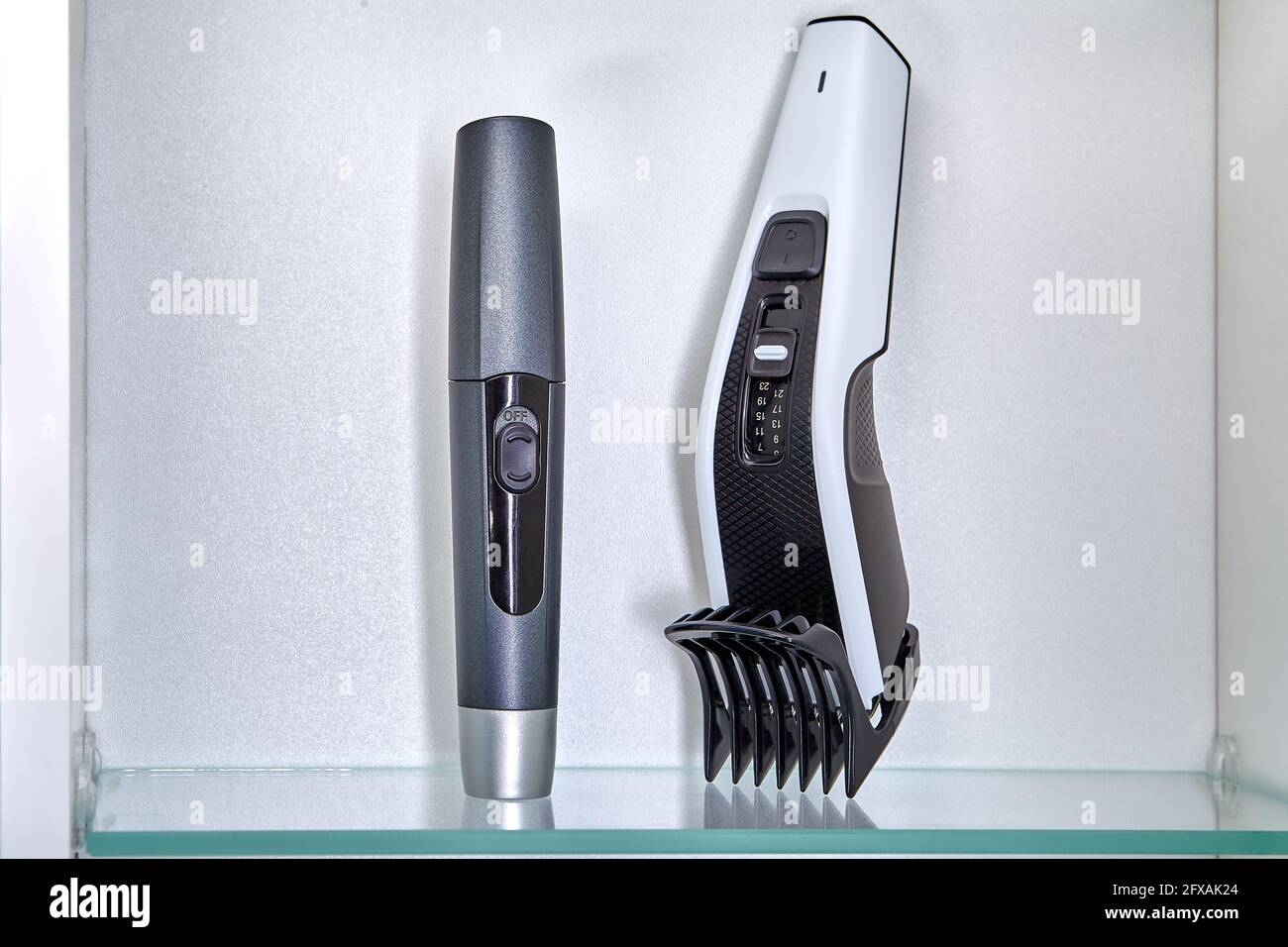 Clipper and trimmer to remove hair in nose are on shelf in locker of ...