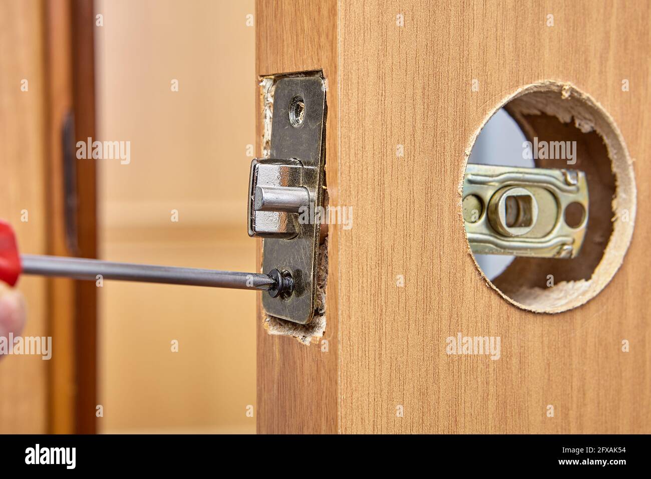 Replacing door lock with handle and latch with new one Stock Photo Alamy