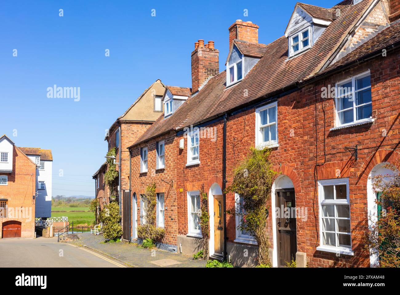 Old Mill workers cottages or houses on Mill street by Tewkesbury Mill Abbey mill water mill Tewkesbury Gloucestershire England GB UK Europe Stock Photo