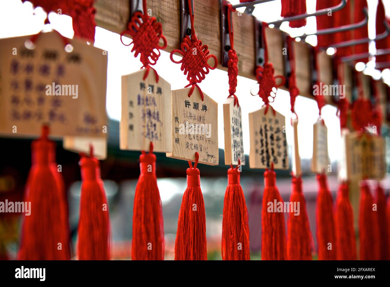 Close up of wooden plaques bearing prayers or wishes hanging up at the Buddhist temple in Toronto, Ontario, Canada Stock Photo