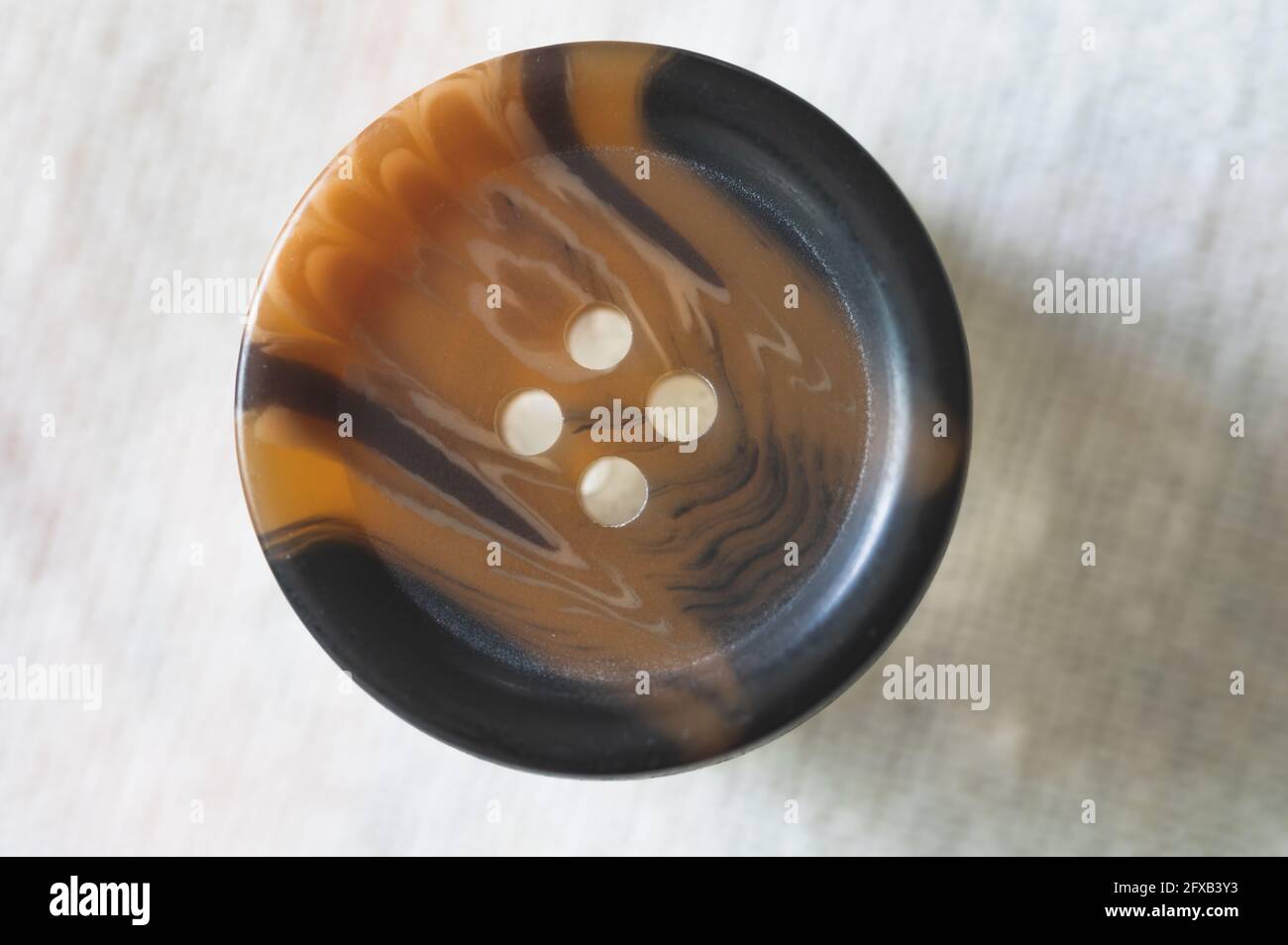 Brown and Black Button on White Background Stock Photo