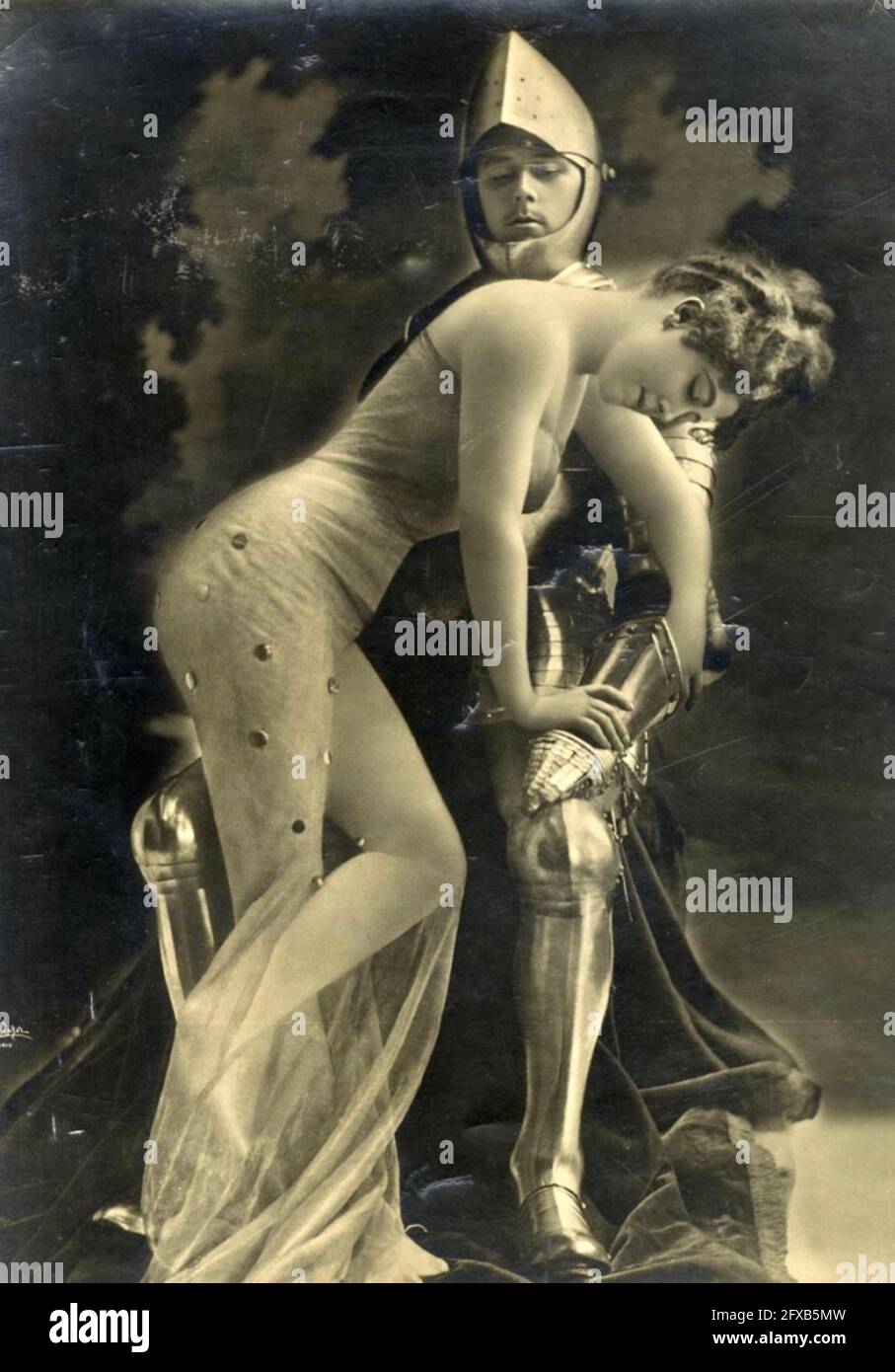Léopold-Émile Reutlinger vintage photograph of a knight in shining armour and a damsel in distress she is not. Stock Photo