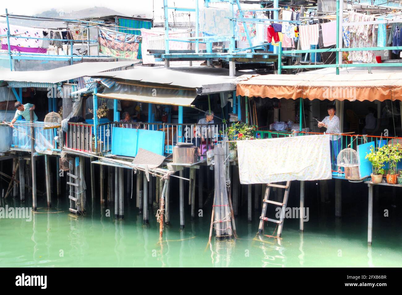 HONG KONG-Apr. 10, 2011: Residents of Tai O fishing from their houses on stilts above the tidal flats of Lantau Island in Hong Kong. Home to the Tanka Stock Photo
