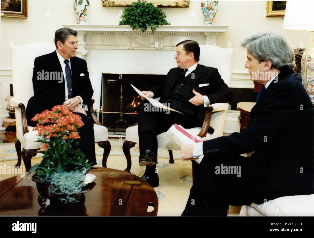 United States President Ronald Reagan, left, meets with U.S. Senators John Tower (Republican of Texas), center, and John Warner (Republican of Virginia), right, in the Oval Office of the White House in Washington, D.C. on Tuesday, January 10, 1984..Mandatory Credit: Pete Souza - White House via CNP /MediaPunch Stock Photo