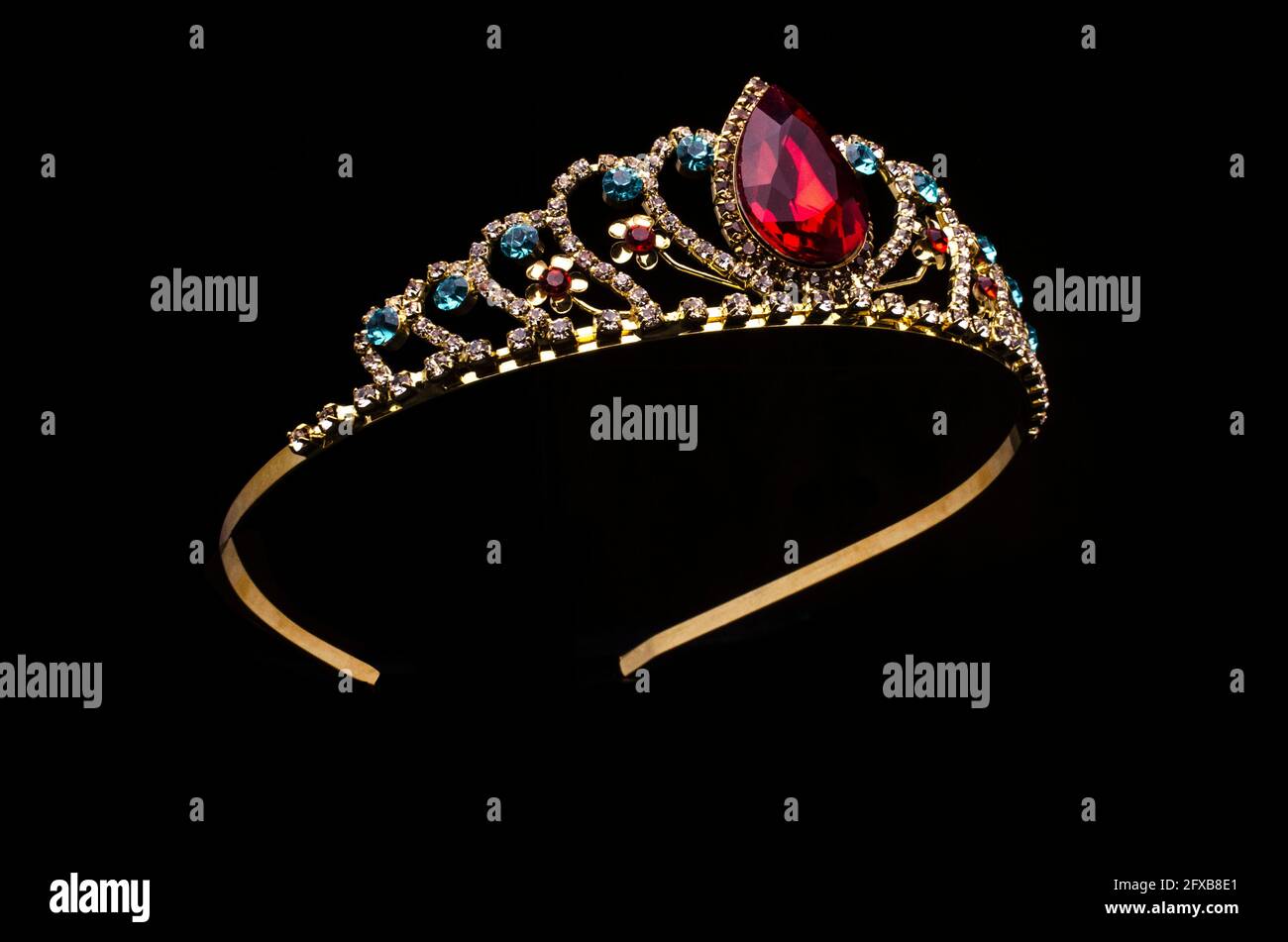 gold crown with red ruby stone isolated on black Stock Photo