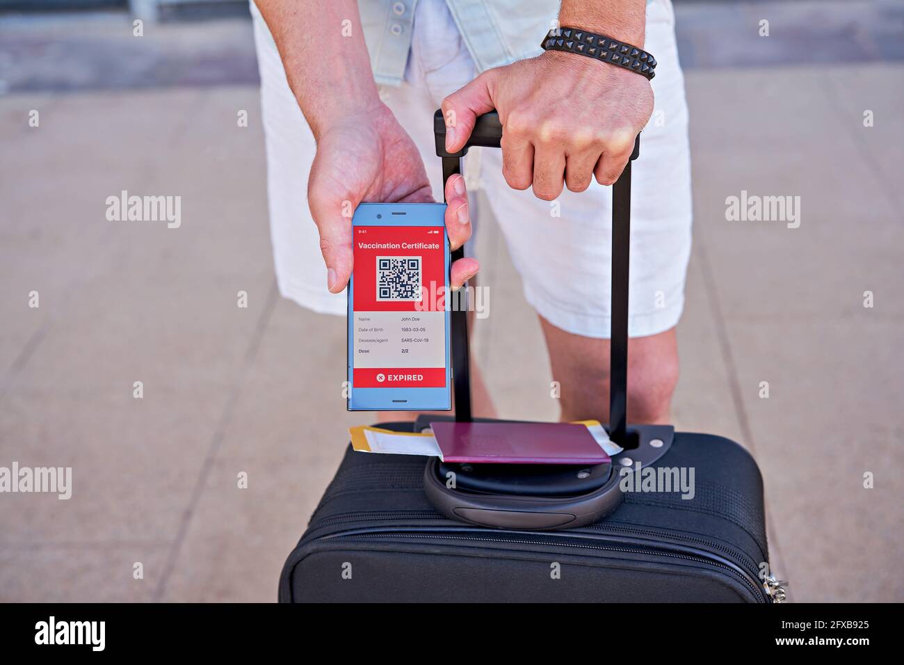 Suitcase and smartphone in hand displaying on app mobile ...