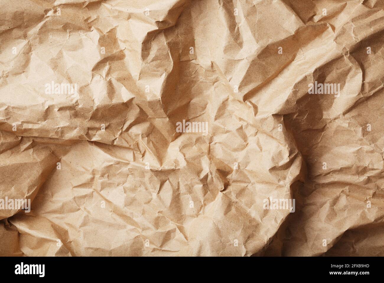 Craft crumpled paper as a texture background. full screen Stock Photo