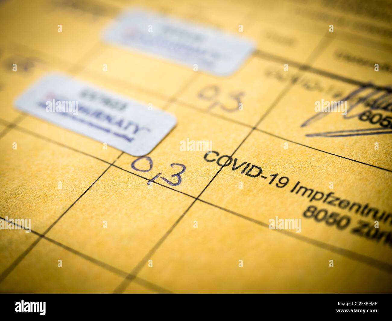 Zurich, Switzerland - 22 May 2021: Close-up of confirmation of two COVID-19 vaccinations in an International Certificate of Vaccination, also known as Carte Jaune or Yellow Card. Stock Photo