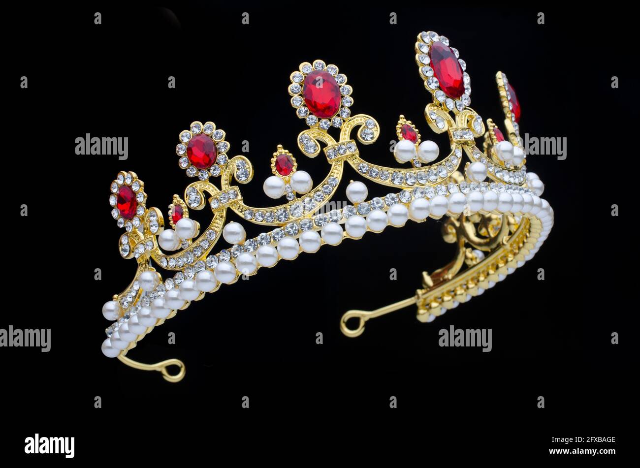 golden crown with rubies and pearls on a black background Stock Photo ...
