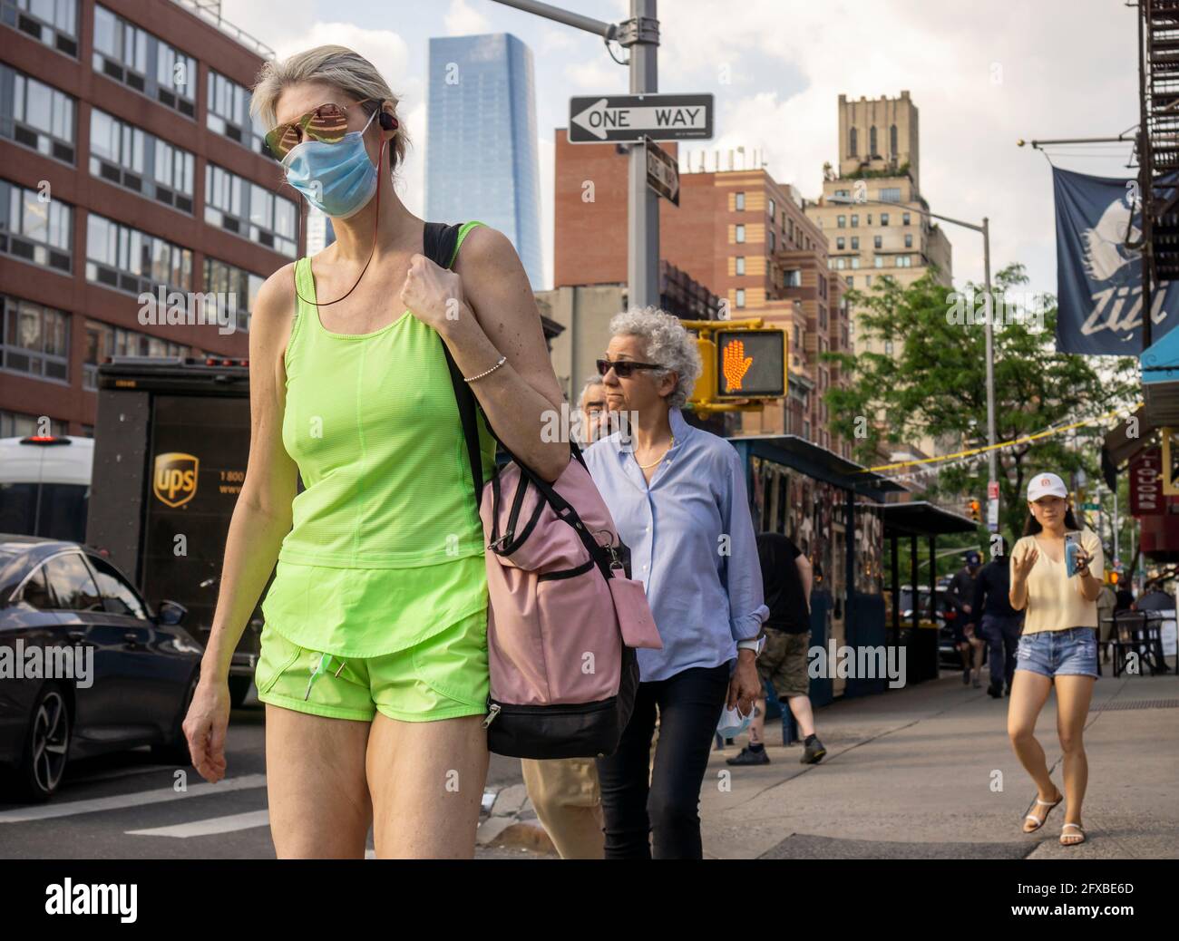 Masked and maskless people in Chelsea in New York on Tuesday, May 18, 2021. New York has relaxed mask mandates allowing most outdoor activities to be mask free as well as many indoor settings, with caveats. (© Richard B. Levine) Stock Photo