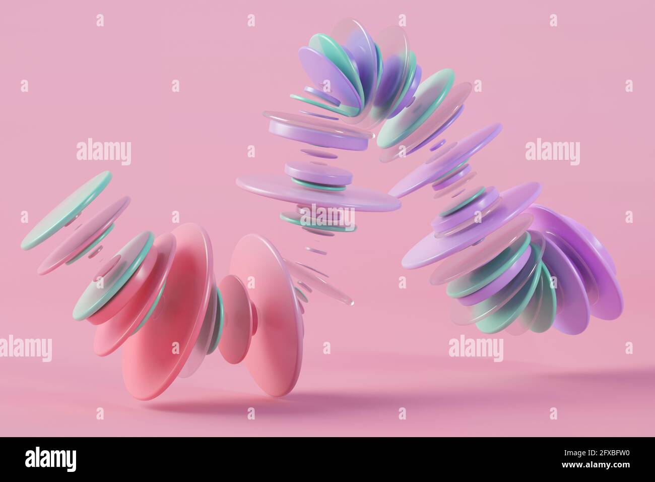 Three dimensional render of pastel colored rings floating against pink ...