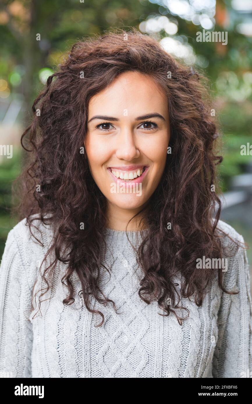 Curly haired woman smiling Stock Photo