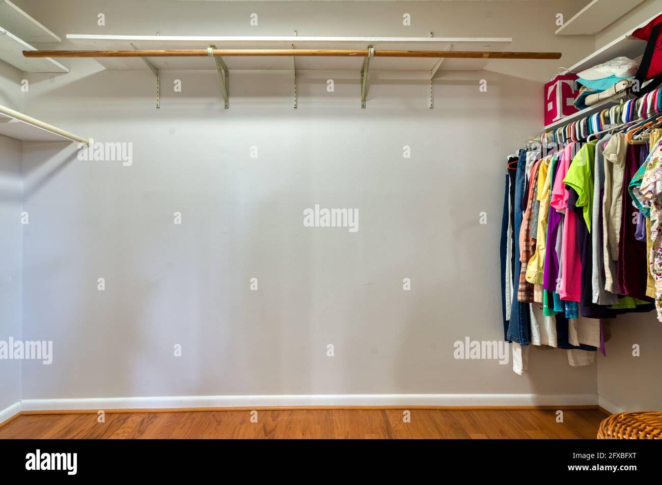 Partially villed walk in closet with blank wall for text Stock Photo