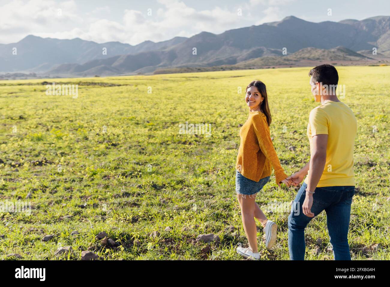 Two young women walking hand hand hi-res stock photography and images ...