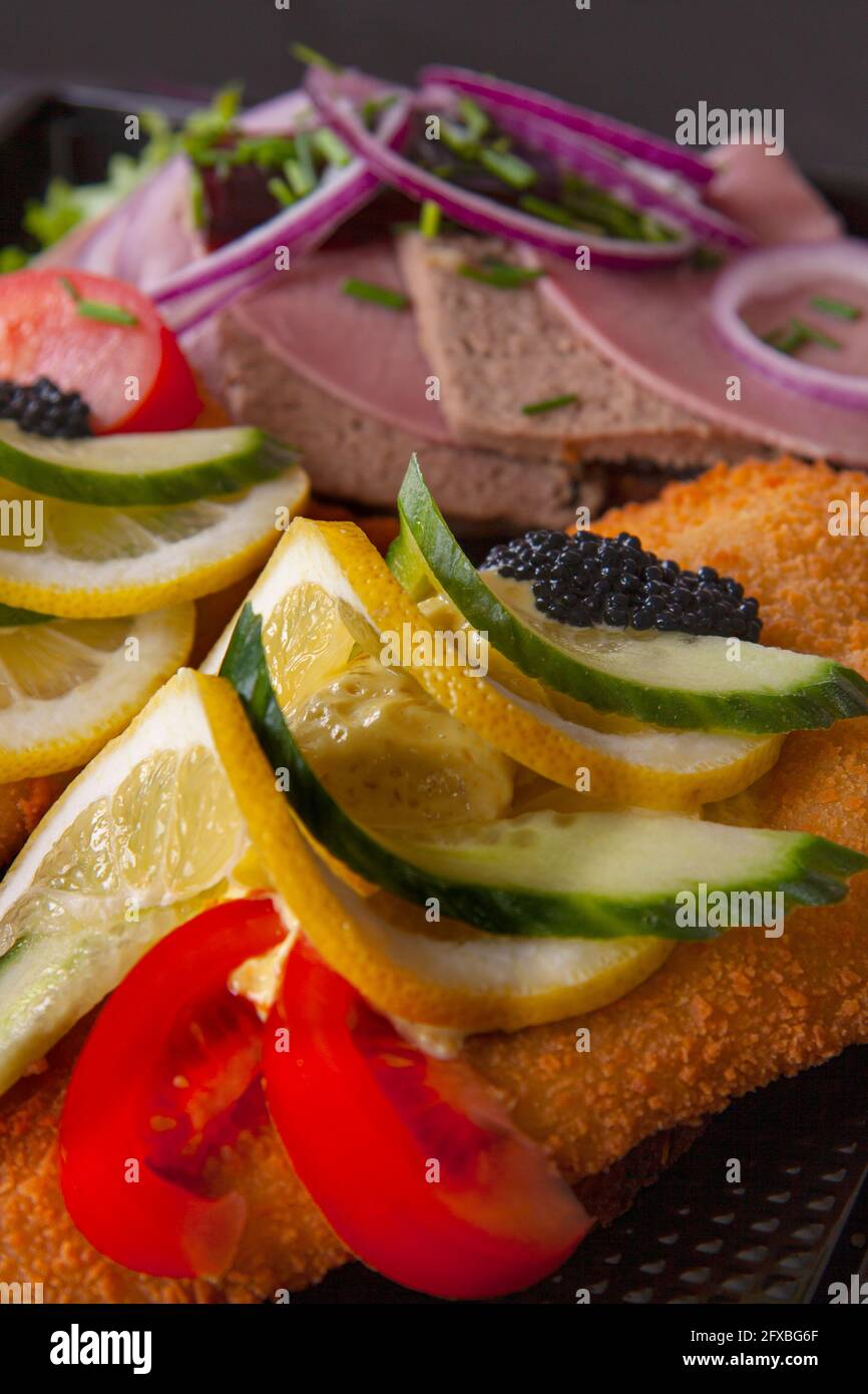 Smorrebrod a traditional Danish open sandwich that consists of a piece of dark rye bread, topped with cold cuts, pieces of meat or fish, cheese or spr Stock Photo