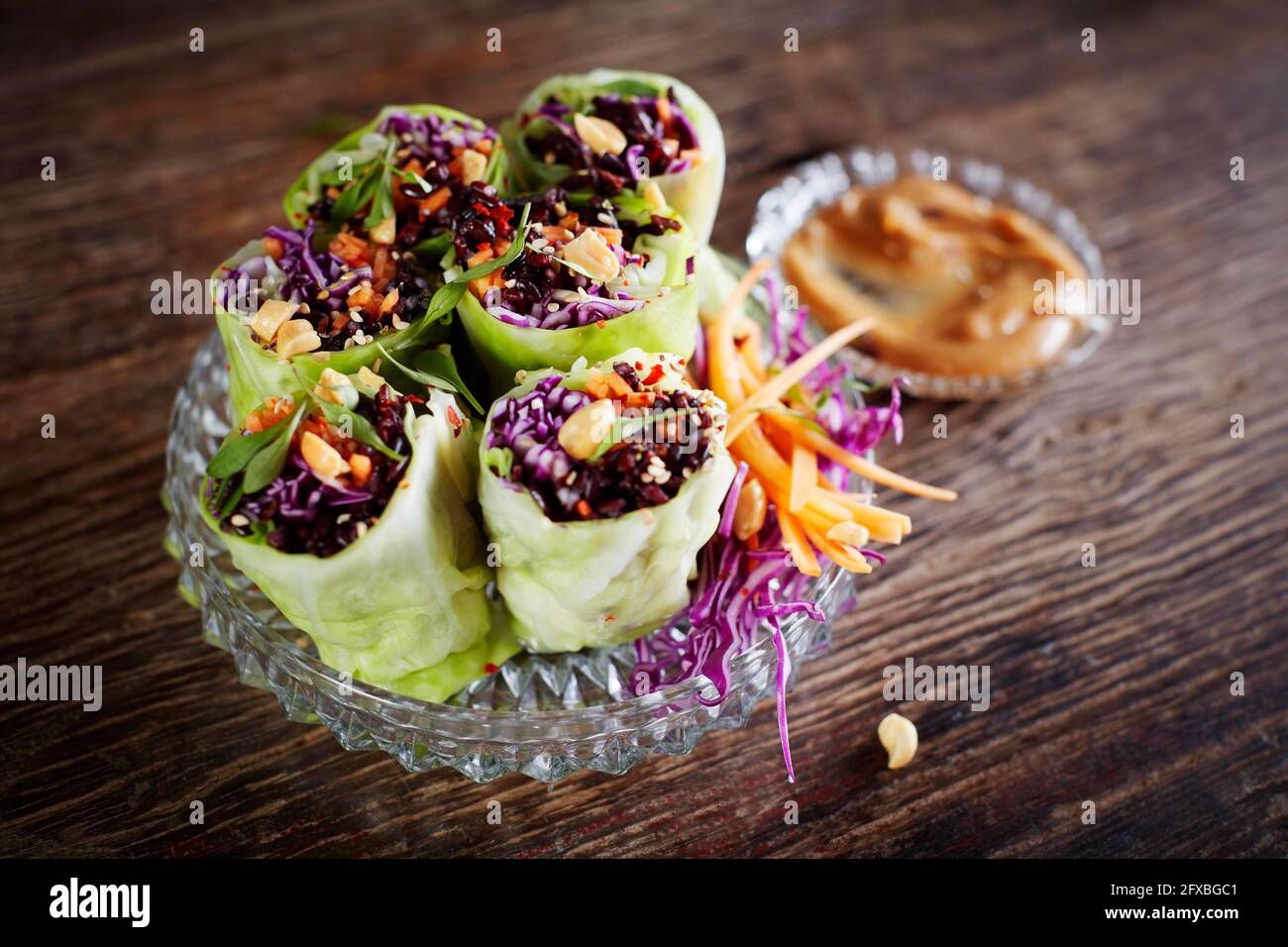 Cabbage rolls with black rice, sesame seeds, carrot and red cabbage