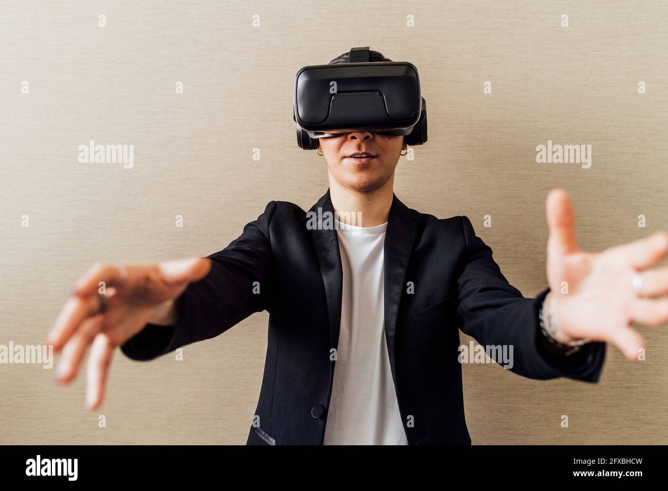 Businesswoman gesturing while using virtual reality headset in office Stock Photo