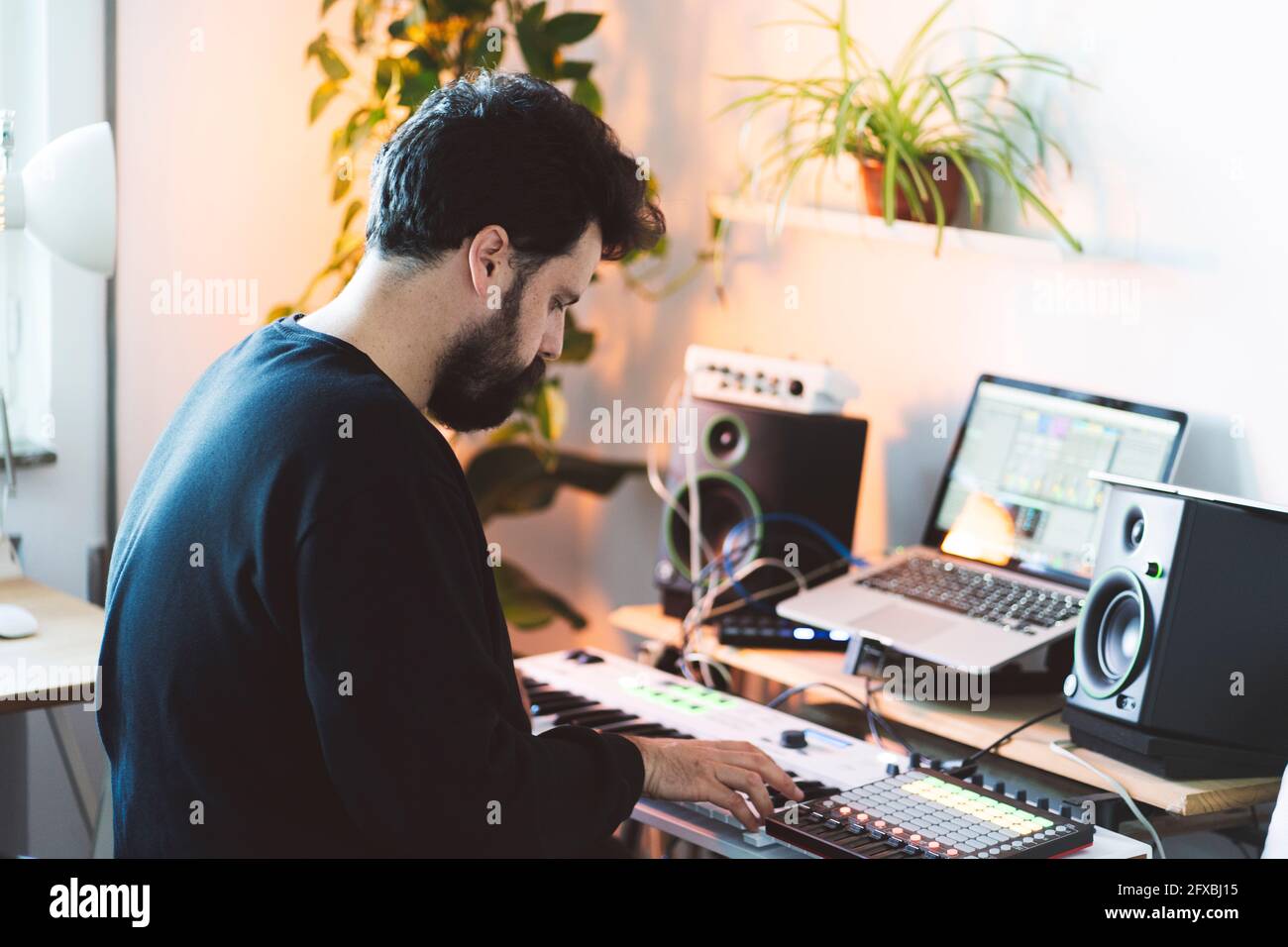 Male music composer using piano in studio Stock Photo