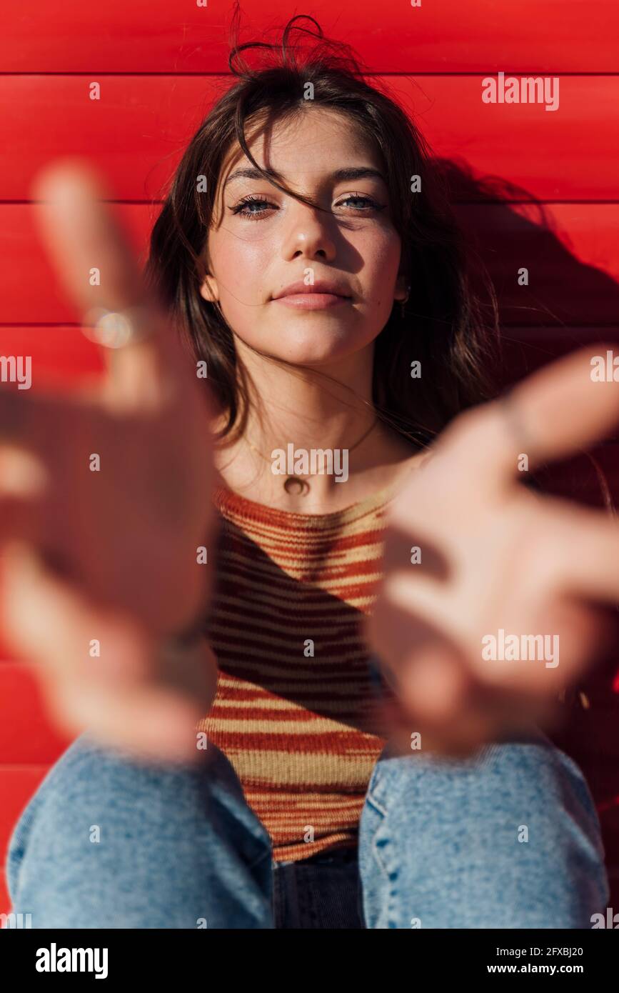 Beautiful teenage girl reaching with hands on sunny day Stock Photo - Alamy
