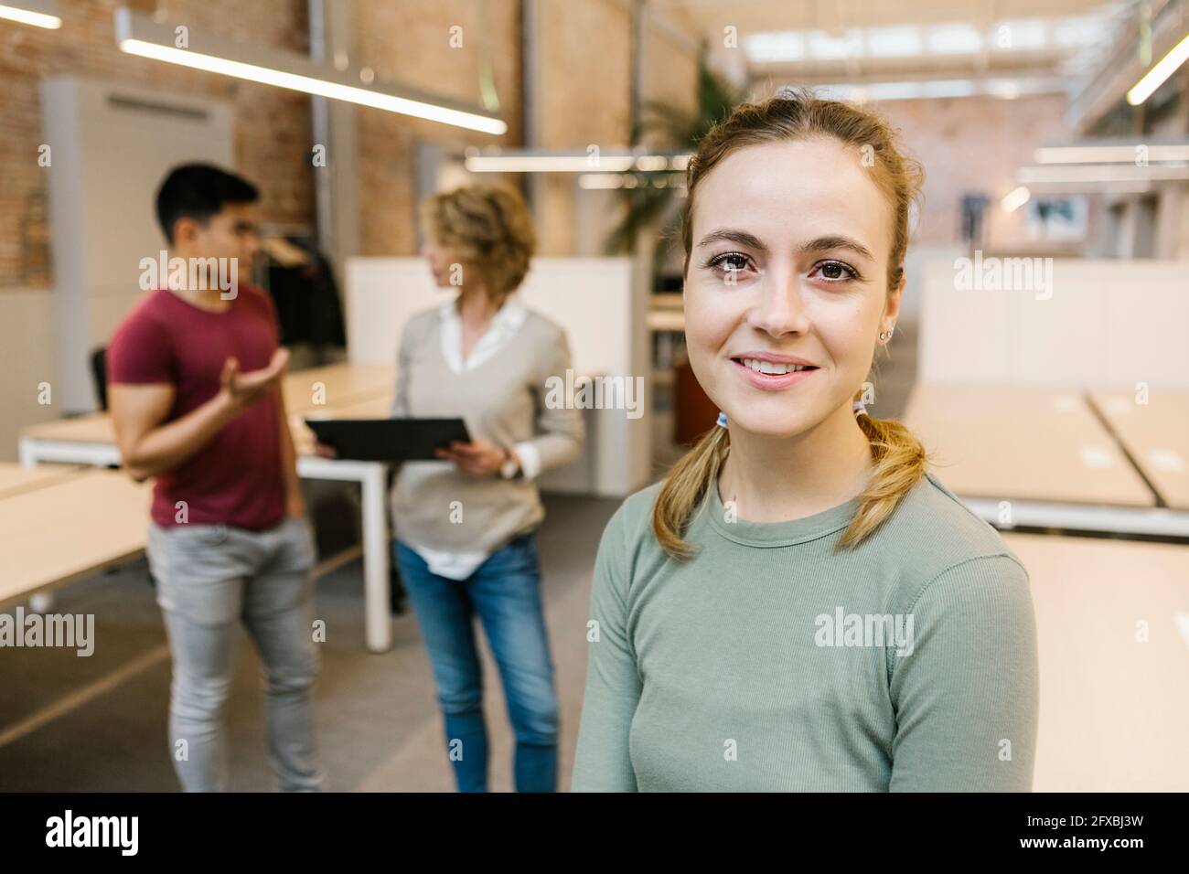 Smiling coworkers in startup hi-res stock photography and images - Alamy