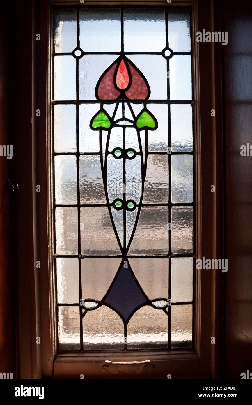 Art nouveau window with tulip design at the Rhu Inn, Scotland Stock Photo