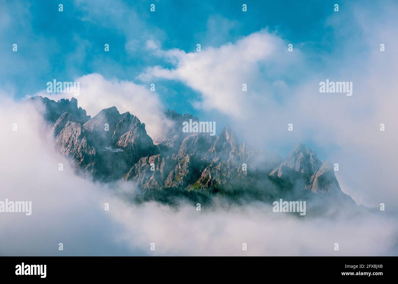 Clouds over mountain peaks in the Dolomites, Italy Stock Photo - Alamy