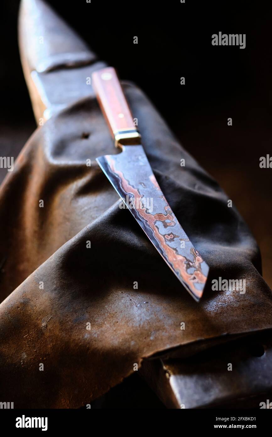 Knife on apron at workshop Stock Photo