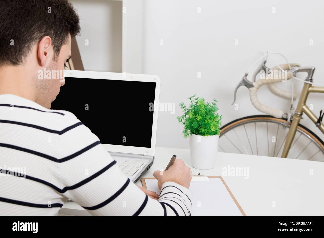 young man studying or working in the home or office with laptop computer Stock Photo