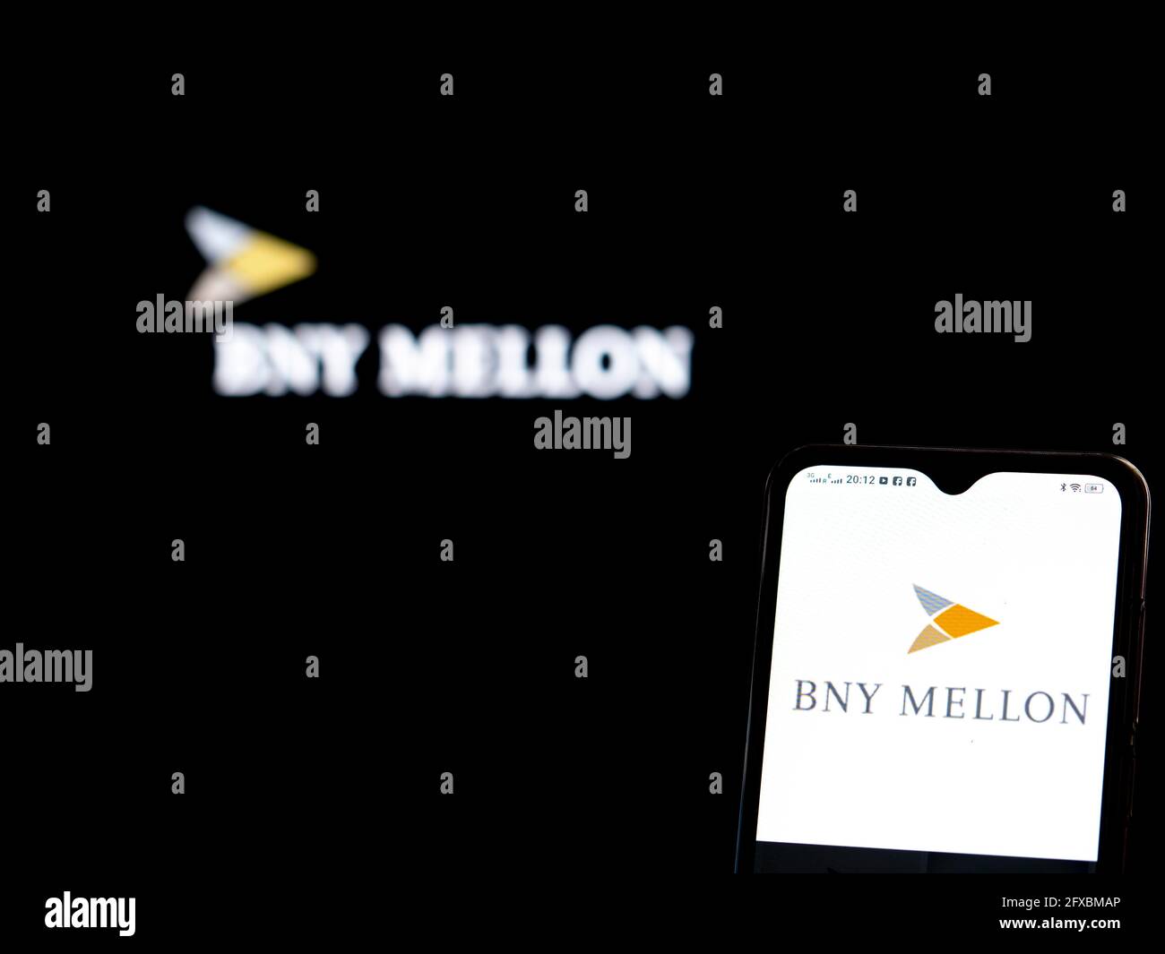 In this photo illustration, The Bank of New York Mellon logo seen displayed on a smartphone and