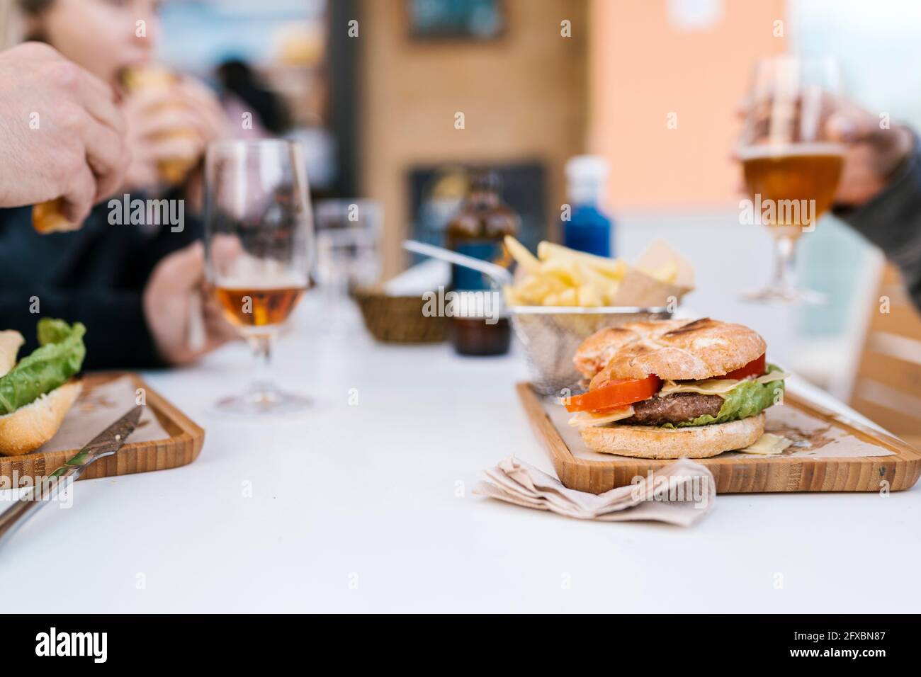 Friends enjoying drinks and food at a bar Stock Photo Alamy