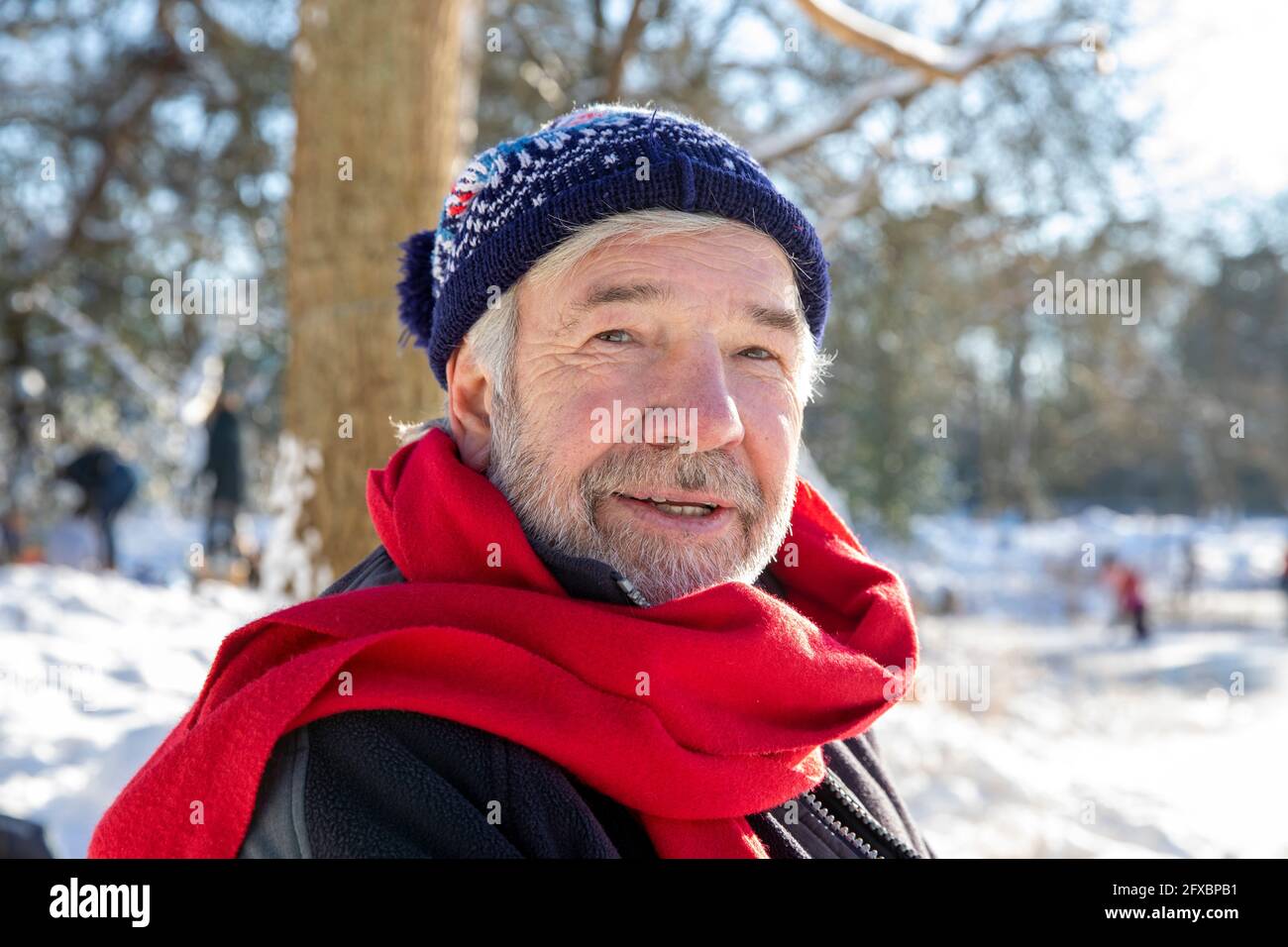 Senior man wearing red scarf during winter Stock Photo