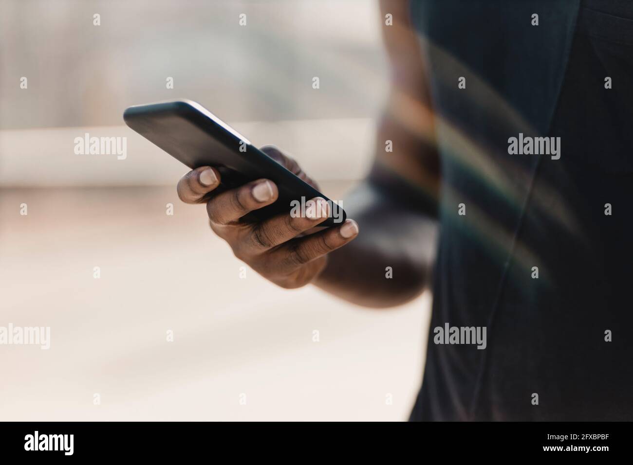 Man using mobile phone outdoors Stock Photo