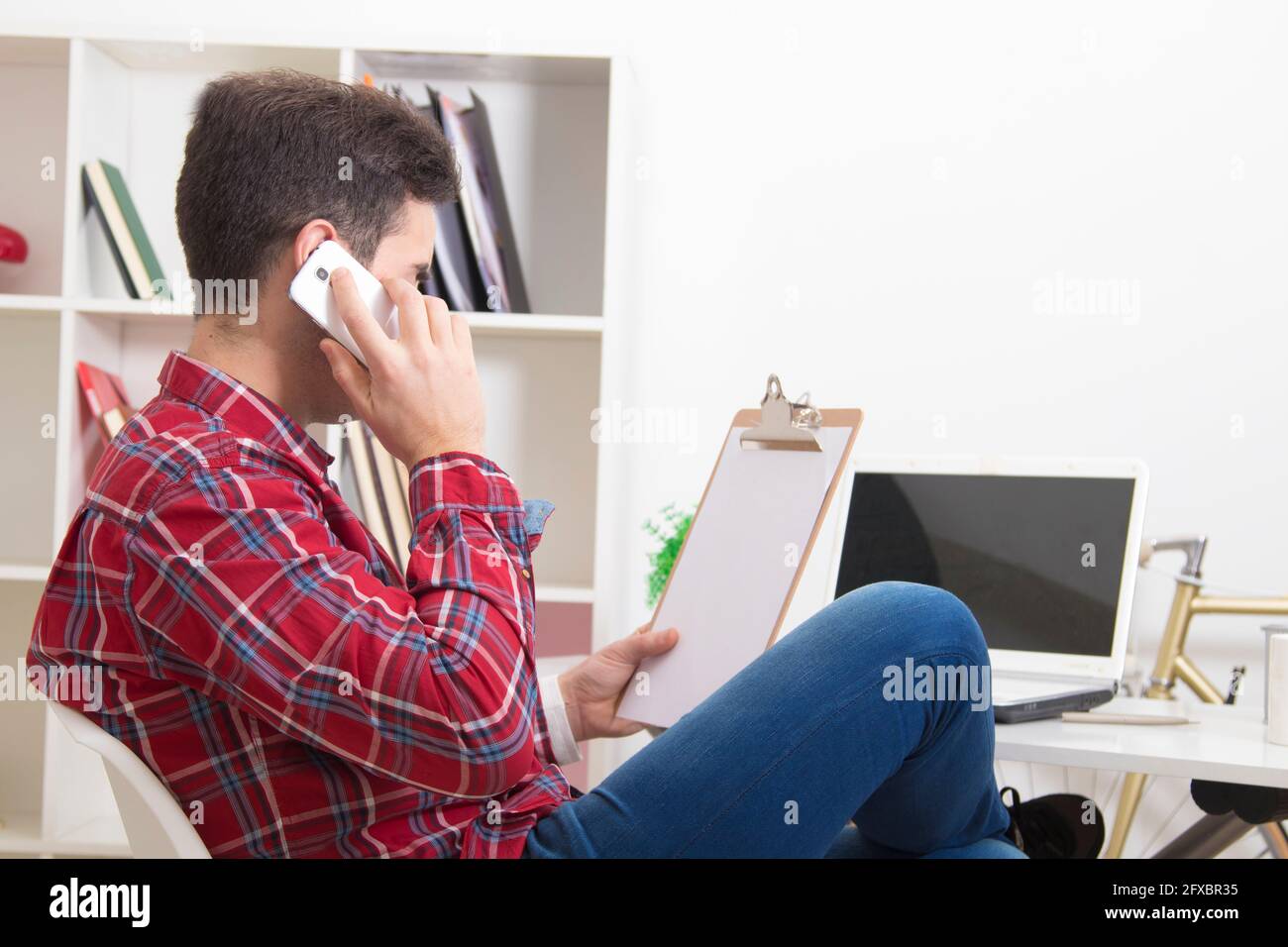 man talking on the phone at home in the office Stock Photo